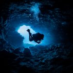 Underwater Divers Exploring Hidden Treasures